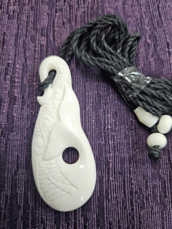 Bone carving whale tail pendant